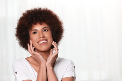 Portrait of beautiful young woman on light background. Space for text