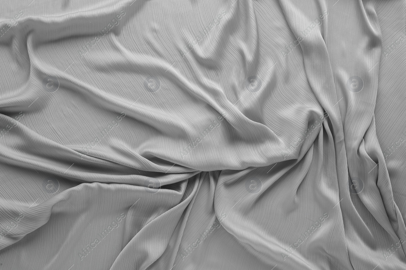 Photo of Beautiful grey tulle fabric as background, top view