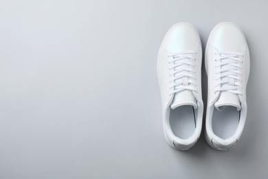 Photo of Pair of trendy sneakers on light background, flat lay. Space for text