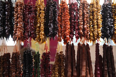 Bunches of different delicious churchkhelas at market