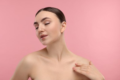 Photo of Portrait of beautiful woman on pink background