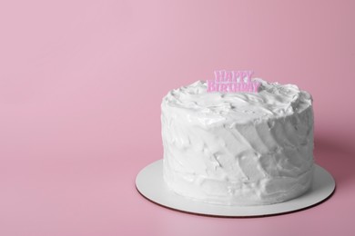 Photo of Delicious cake with cream and words Happy Birthday on pink background. Space for text