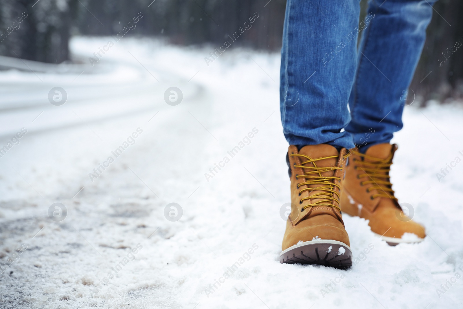 Photo of Man walking outdoors on snowy winter day. Space for text