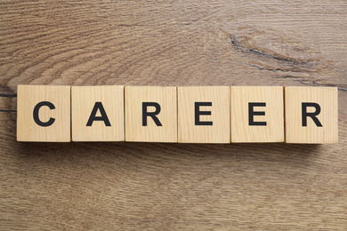 Cubes with word CAREER on wooden background, flat lay