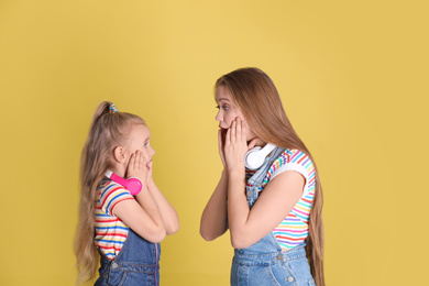 Photo of Emotional mother and daughter on yellow background