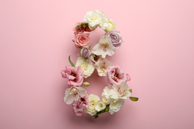 Photo of Number 8 made of beautiful flowers on pink background, flat lay. International Women's day