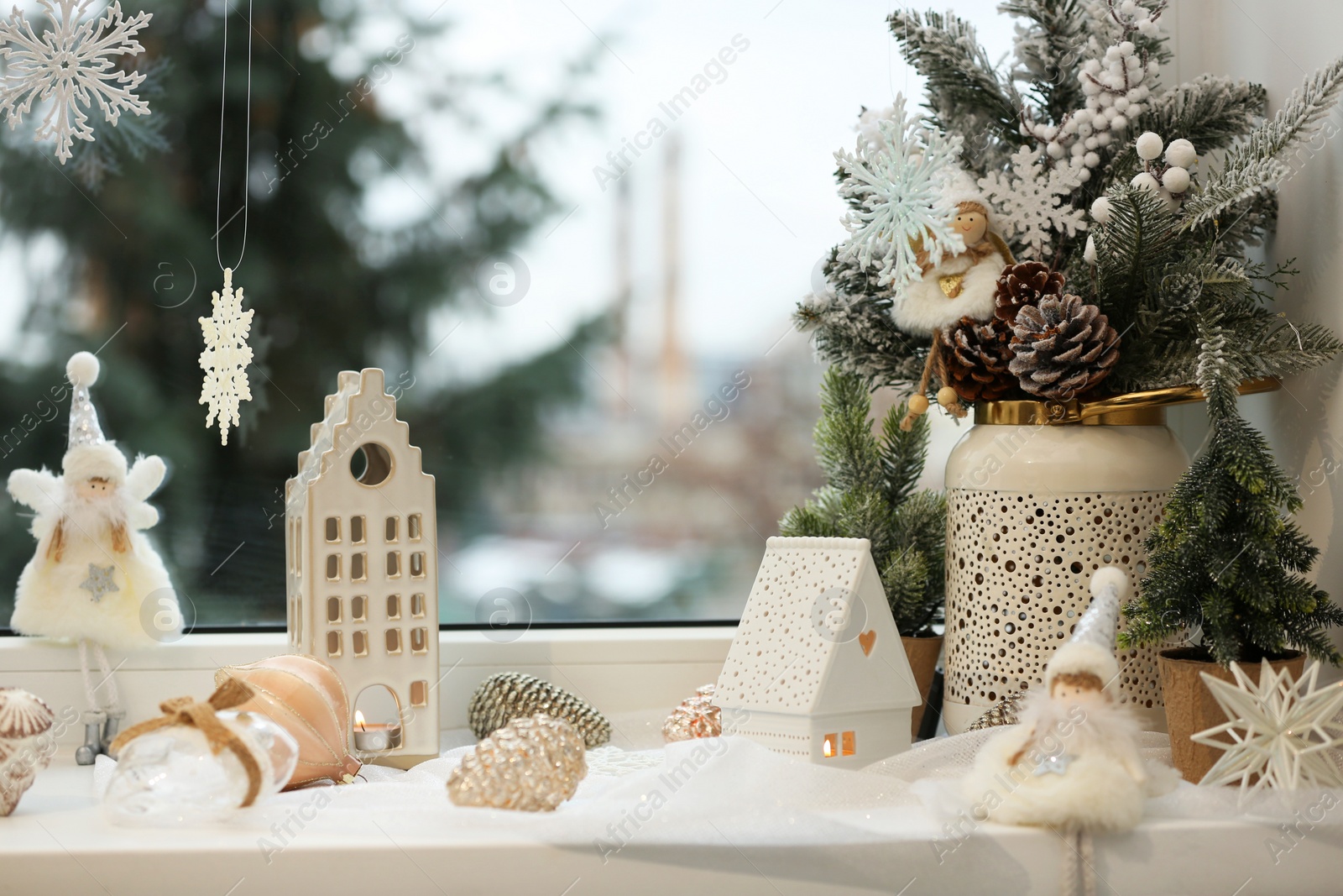 Photo of Many beautiful Christmas decorations and fir branches on window sill indoors