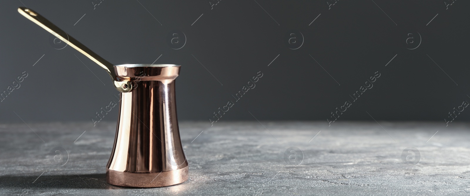 Image of Turkish coffee. Cezve on grey table. Banner design with space for text