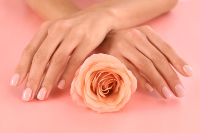 Photo of Closeup view of woman with rose on color background. Spa treatment