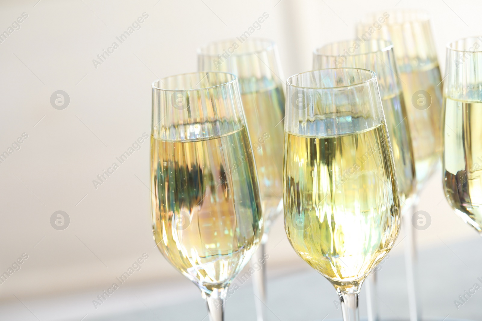 Photo of Glasses of champagne on blurred background, closeup view