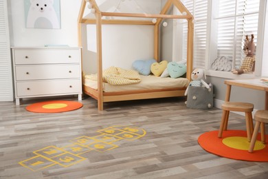 Photo of Yellow hopscotch floor sticker in bedroom at home