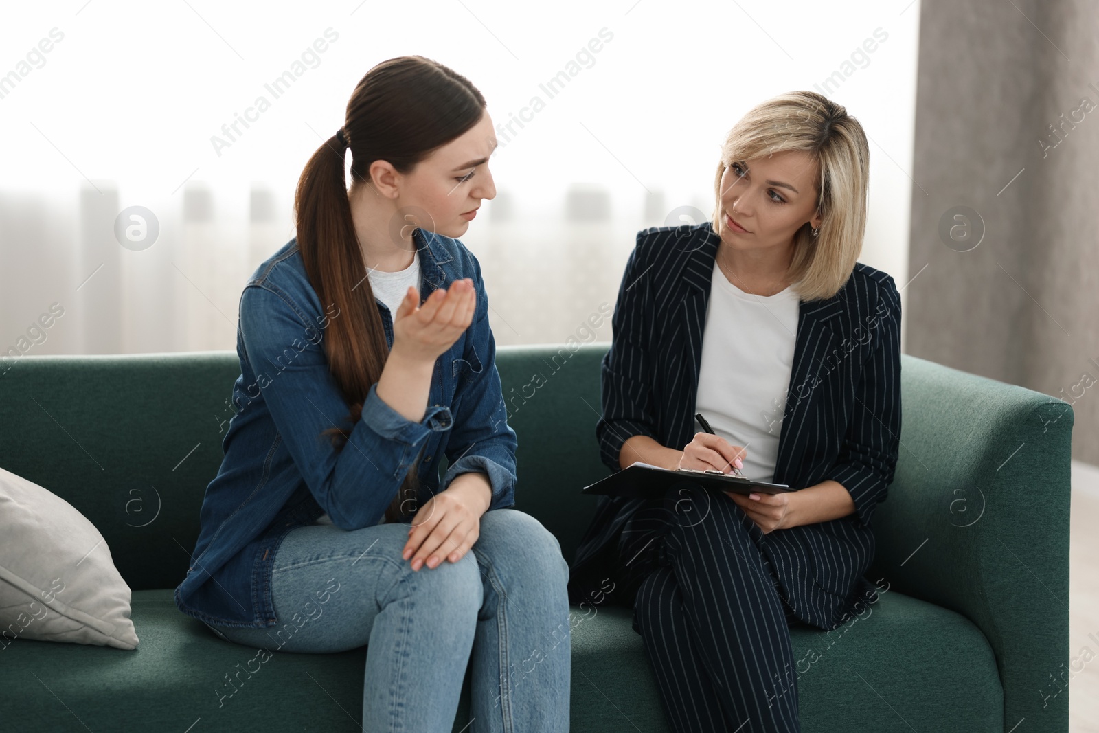 Photo of Psychotherapist working with patient on sofa in office