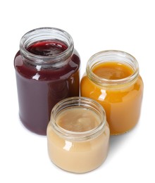 Photo of Baby food. Different healthy puree in jars isolated on white