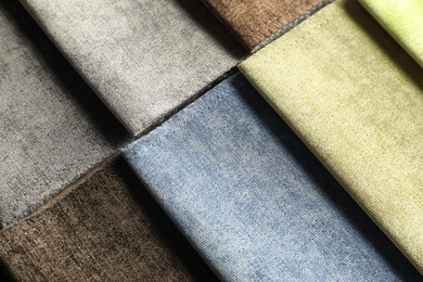 Photo of Fabric samples of different colors for interior design as background