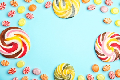 Flat lay composition with delicious colorful candies and space for text on color background