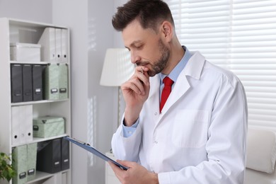 Doctor with clipboard in clinic. Patient consultation