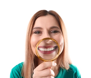 Smiling woman with perfect teeth and magnifier on white background