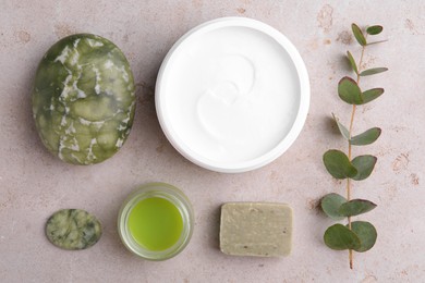 Flat lay composition with jars of cream on light textured table. Body care products