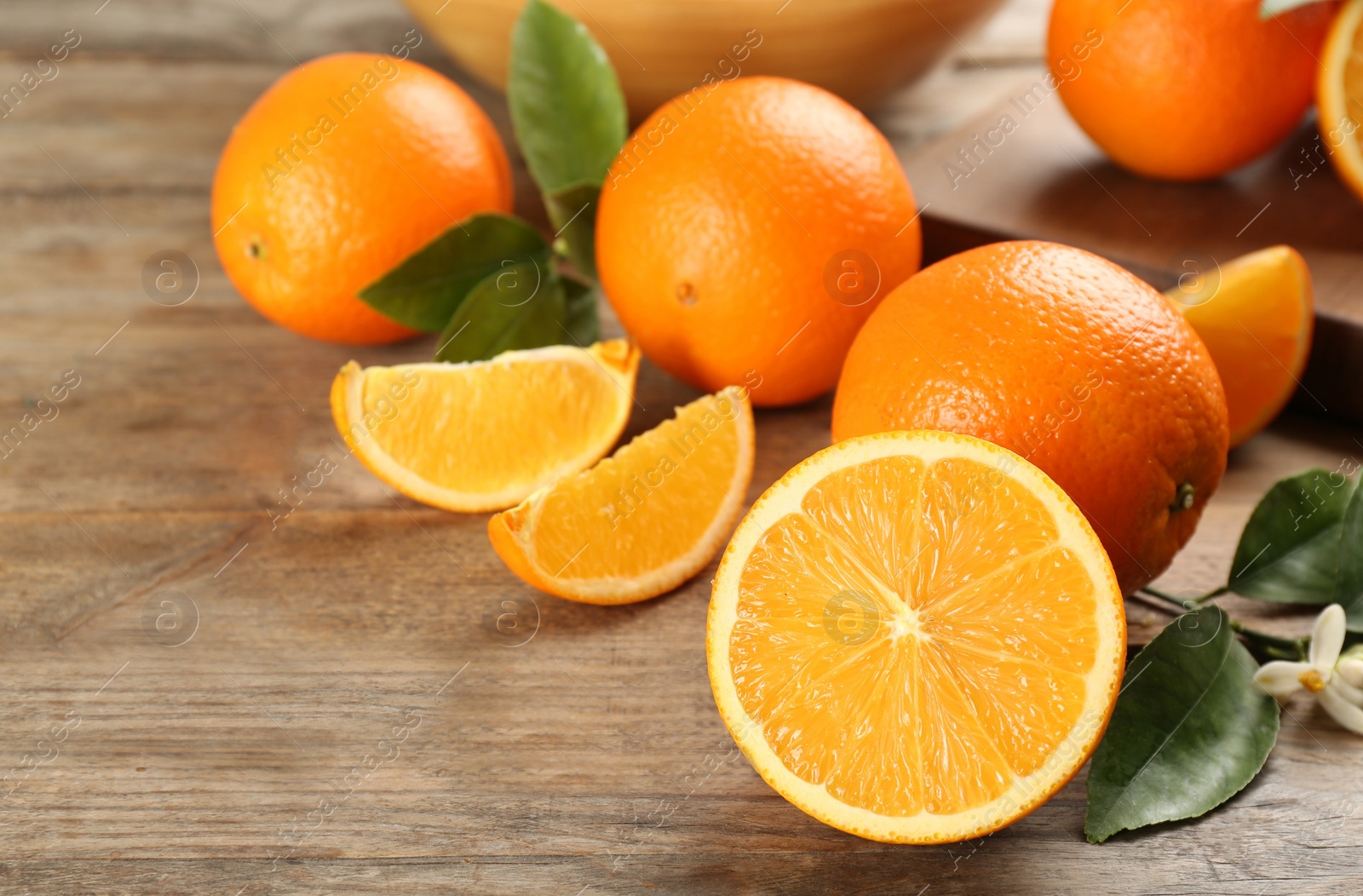 Photo of Many delicious ripe oranges on wooden table