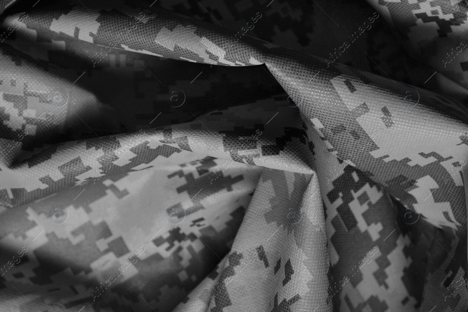 Image of Texture of crumpled camouflage fabric as background, closeup. Black and white effect