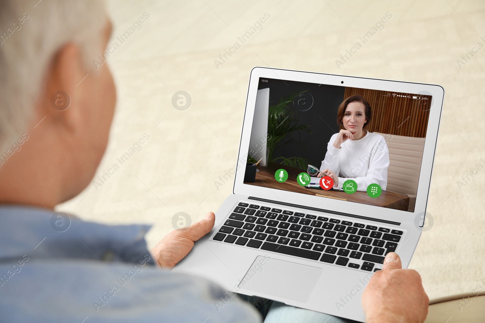 Image of Man using laptop at home for online consultation with psychologist via video chat, focus on screen