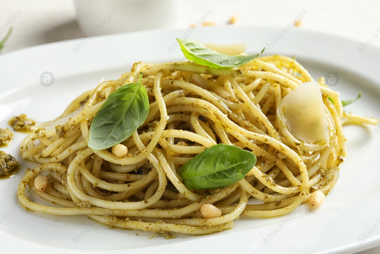 Photo of Delicious basil pesto pasta on plate, closeup