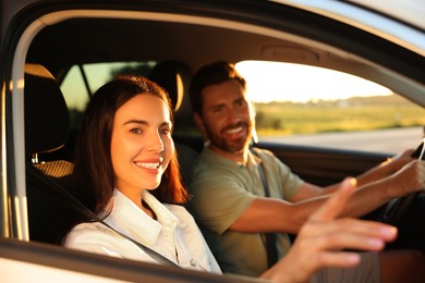 Happy couple enjoying trip together by car, selective focus