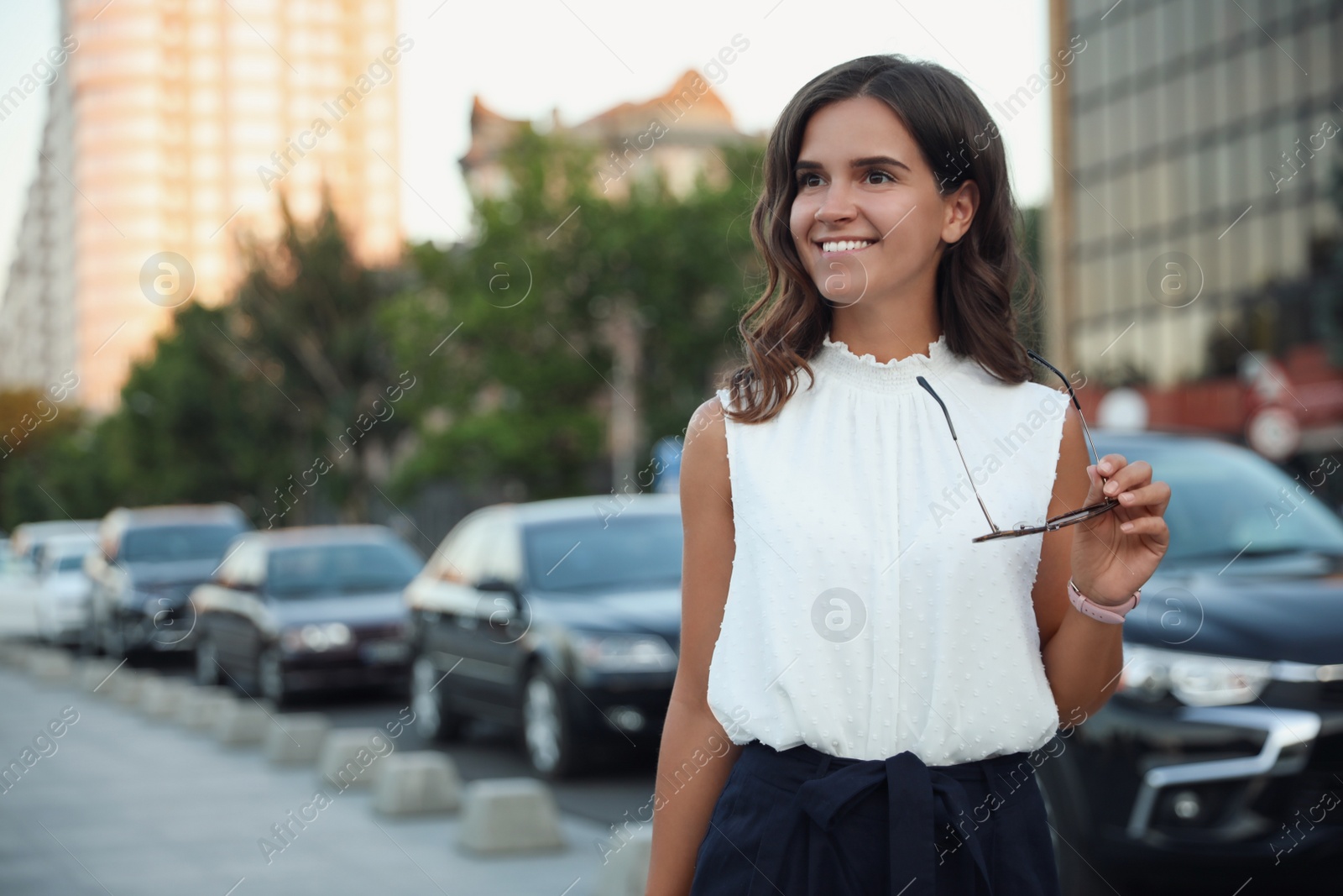 Photo of Young woman walking on modern city street