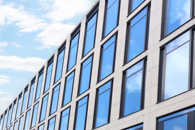 Photo of Modern building against blue sky, low angle view