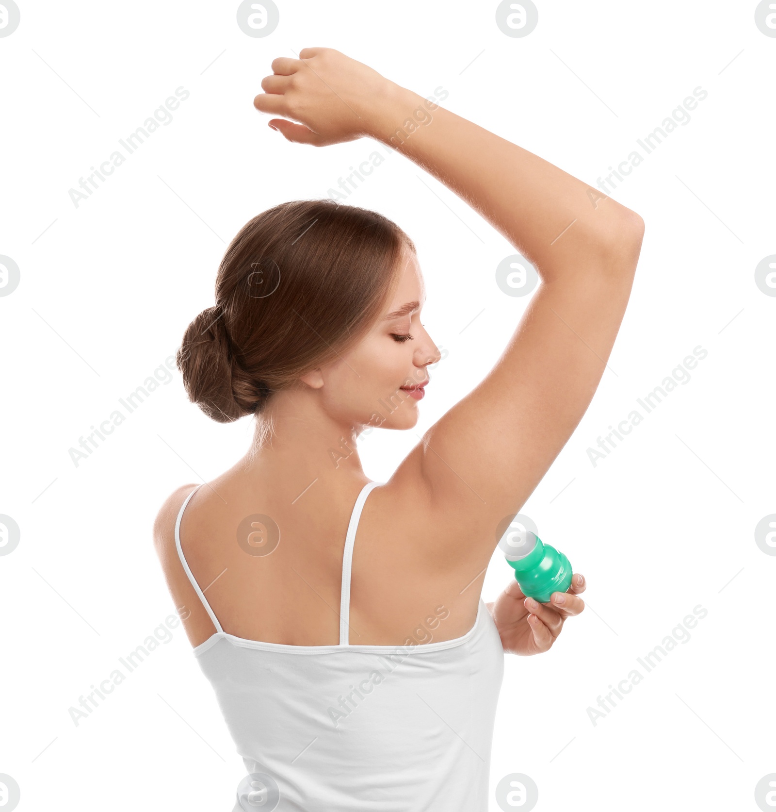 Photo of Young woman applying deodorant to armpit on white background