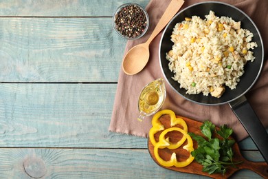 Photo of Delicious chicken risotto served on light blue wooden table, flat lay. Space for text