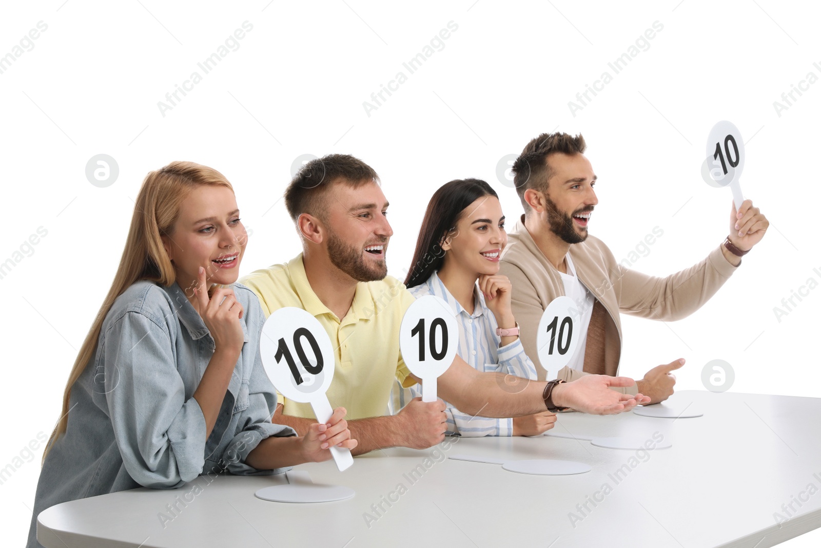 Photo of Panel of judges holding signs with highest score at table on white background