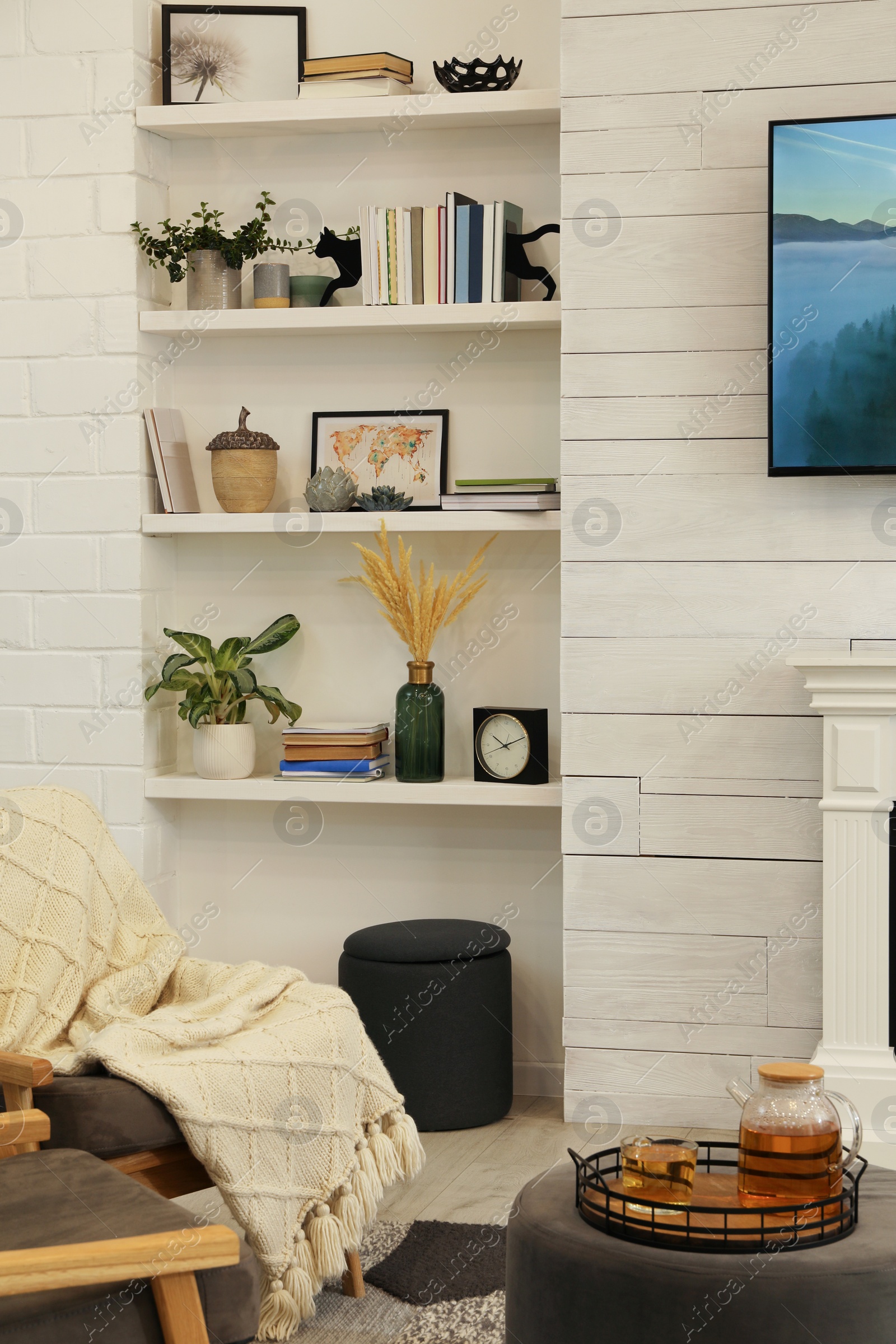 Photo of Cozy living room interior with comfortable armchairs and ottoman