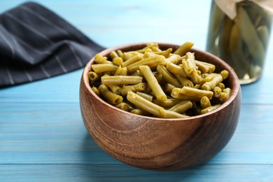 Photo of Canned green beans on light blue wooden table
