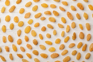 Photo of Flat lay composition with raisins on white wooden background. Dried fruit as healthy snack