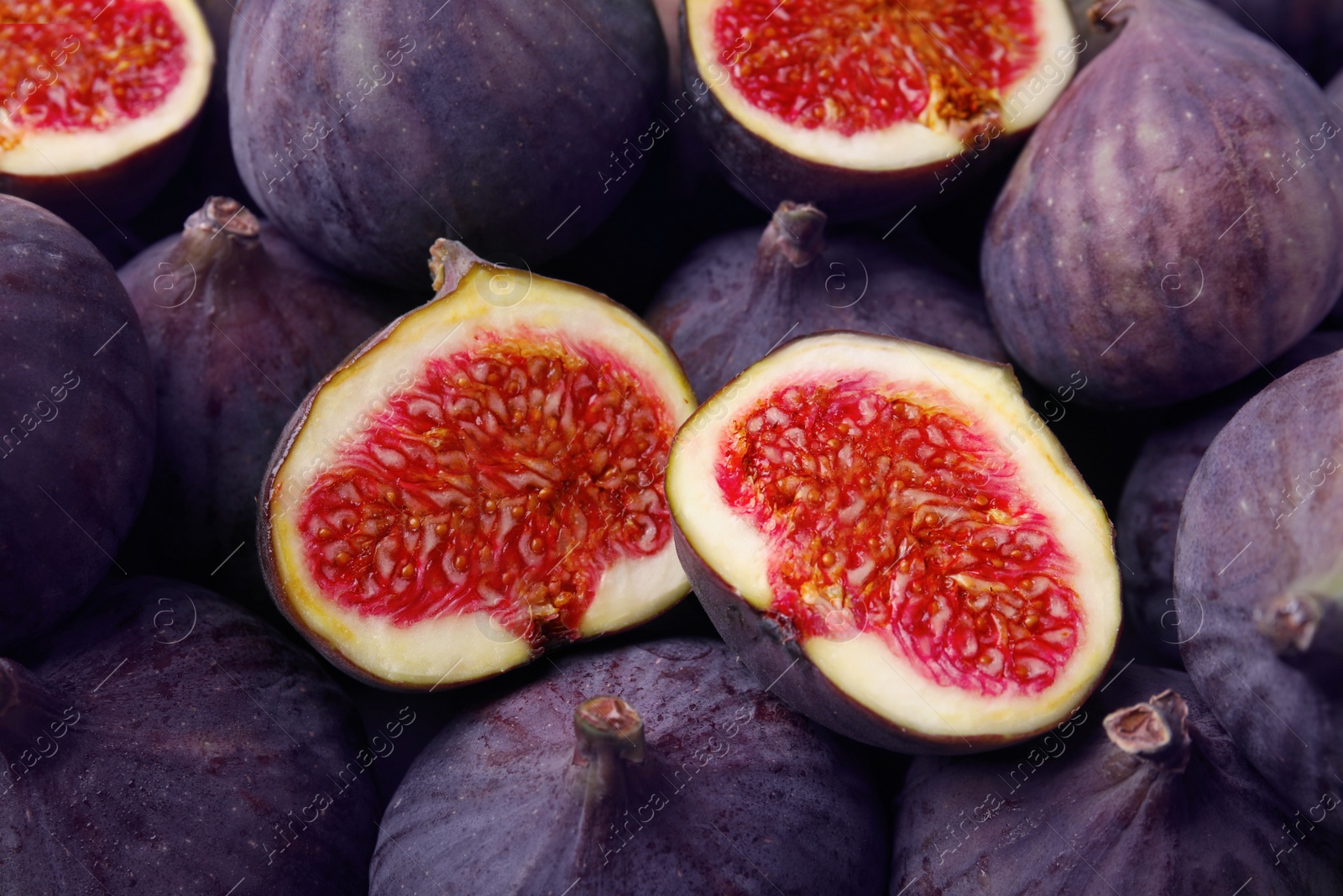 Photo of Cut and whole fresh ripe figs as background, top view