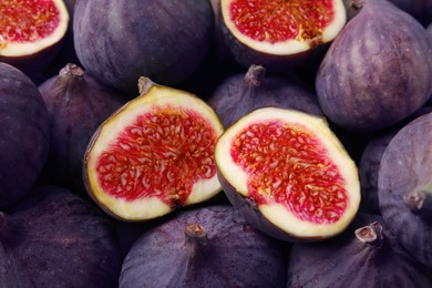 Photo of Cut and whole fresh ripe figs as background, top view