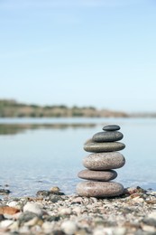 Photo of Stack of stones on beach, space for text. Harmony and balance concept
