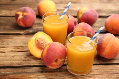 Photo of Natural peach juice and fresh fruits on wooden table