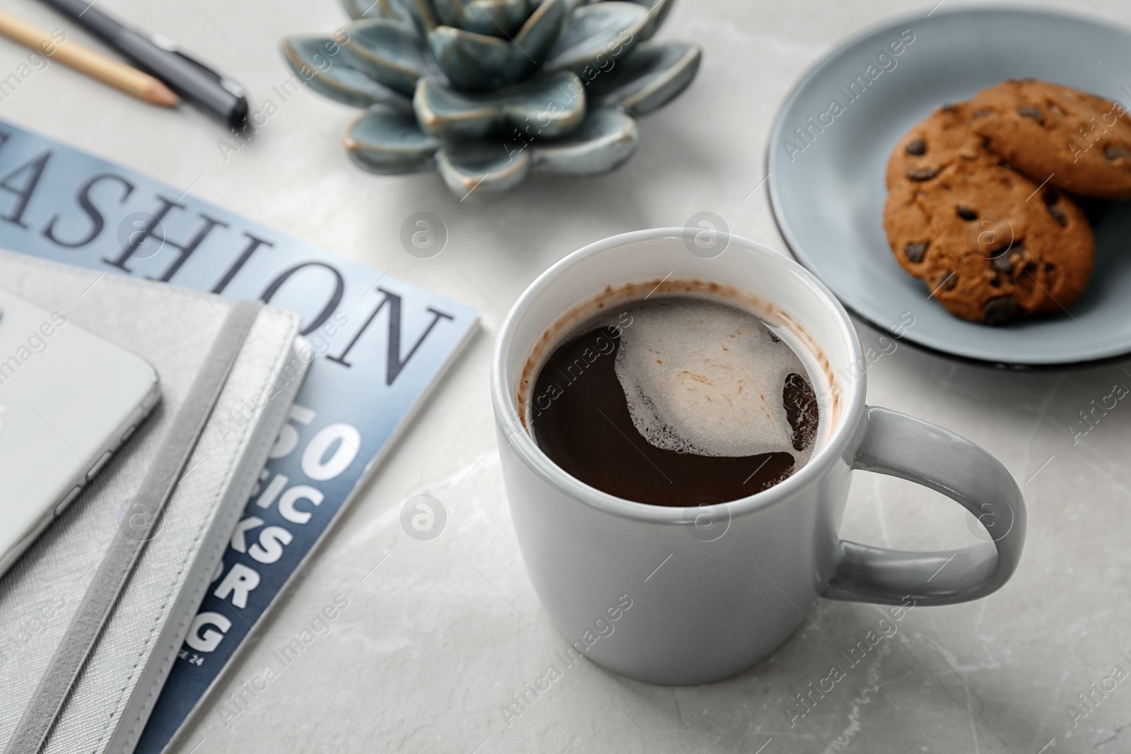 Photo of Cup of delicious hot coffee on table