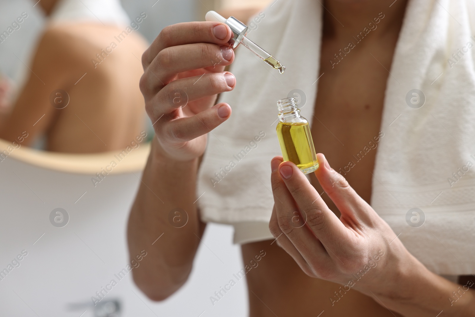 Photo of Man with serum in bathroom, closeup view