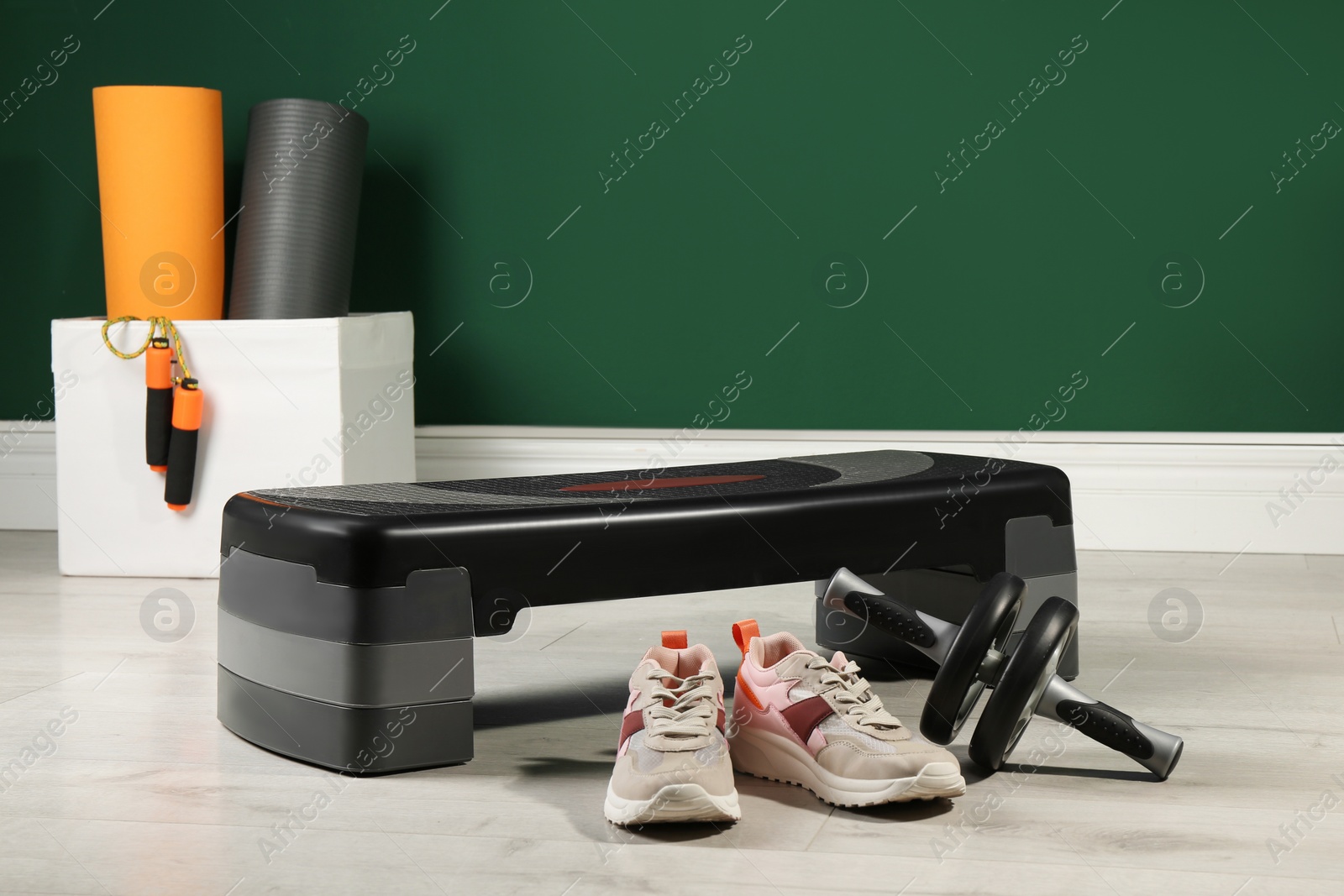 Photo of Step platform and different sports equipment indoors