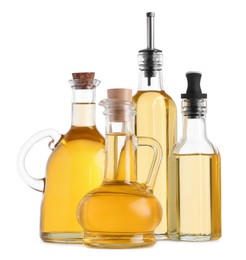 Photo of Different glass bottles of cooking oil on white background