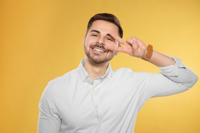 Photo of Portrait of handsome young man on color background