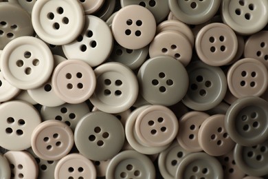 Photo of Many plastic sewing buttons as background, closeup