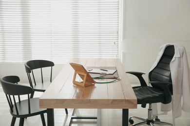 Photo of Modern doctor's workplace in stylish office. Interior design