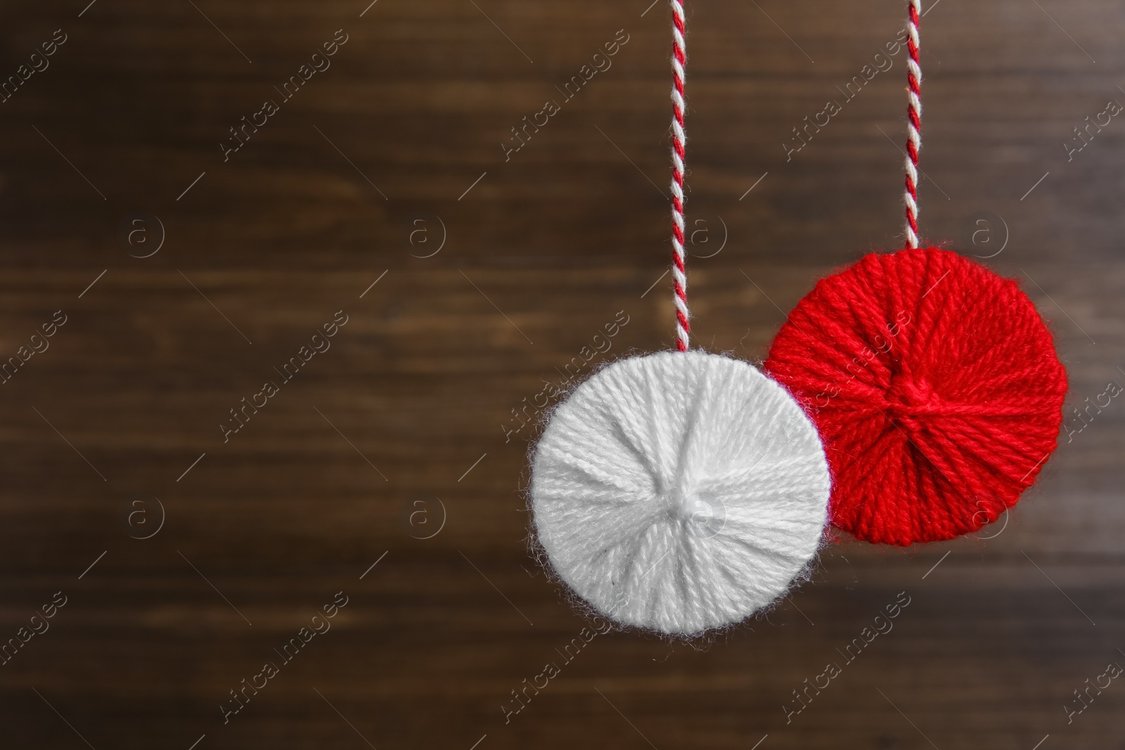 Photo of Traditional martisor on wooden background, space for text. Beginning of spring celebration