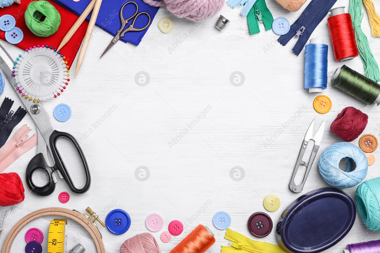 Photo of Flat lay composition with sewing threads and accessories on wooden background