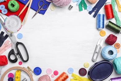 Photo of Flat lay composition with sewing threads and accessories on wooden background