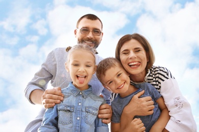 Photo of Happy family spending time together with their children outdoors
